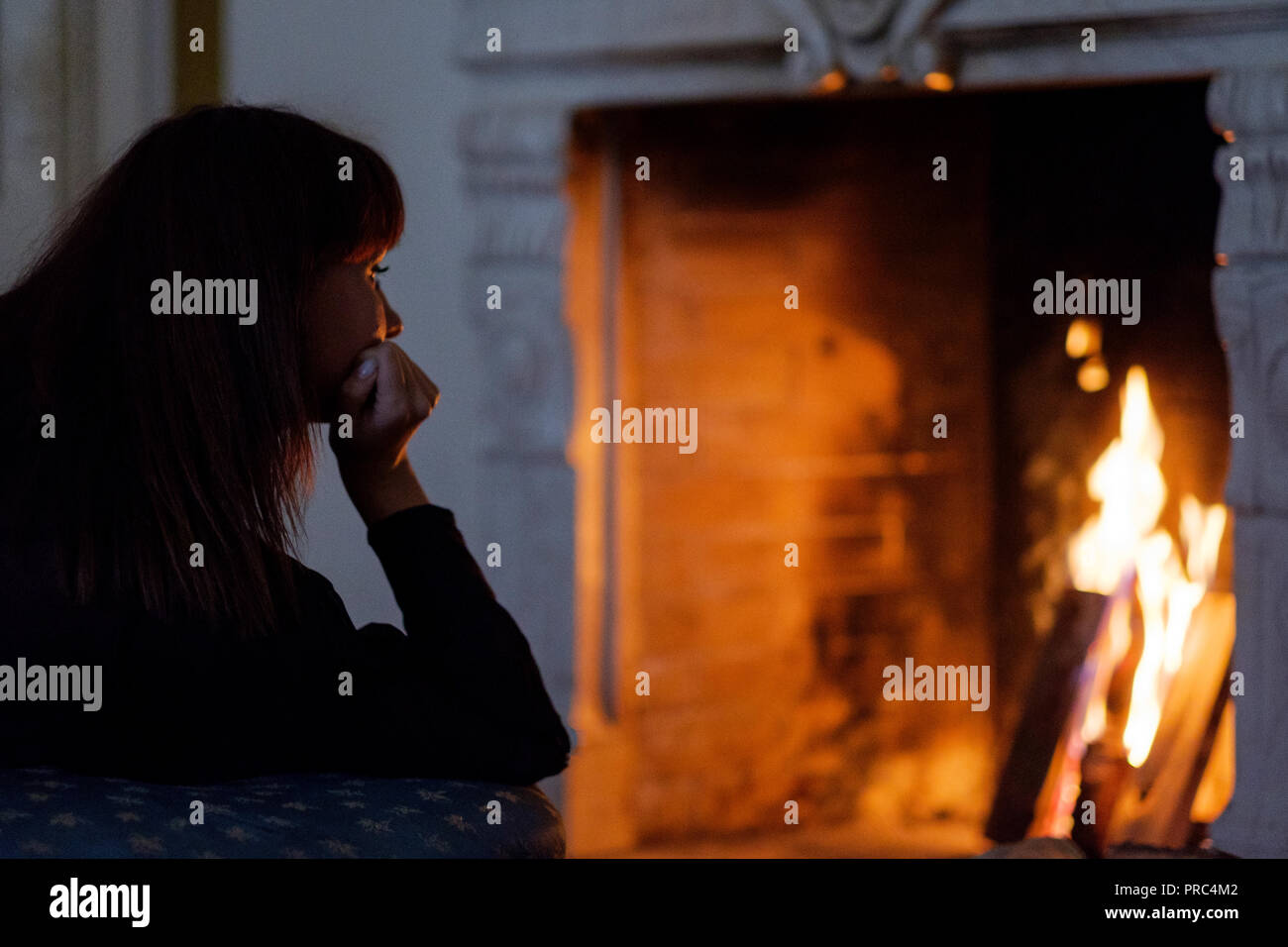 Portrait of attractive woman looking on fire, daydreaming in front of fireplace Stock Photo - Alamy Portrait of attractive woman looking on fire, daydreaming in front of fireplace Stock Photo - Alamy