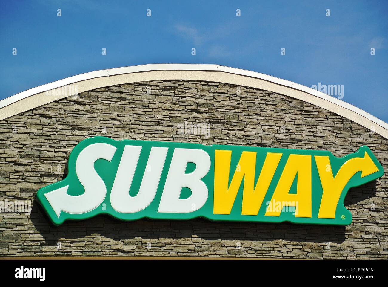 A close up of a pretty white, yellow and green logo of a fast food restaurant Subway on a sunny day at Charlottetown, Prince Edward Island, Canada Stock Photo