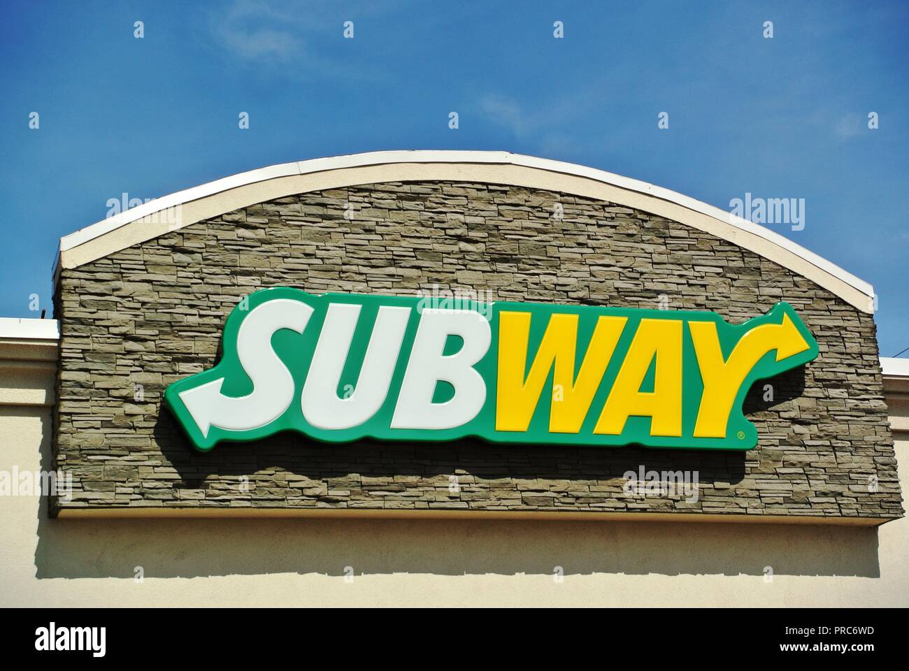 A close up of a pretty white, yellow and green logo of a fast food restaurant Subway on a sunny day at Charlottetown, Prince Edward Island, Canada Stock Photo