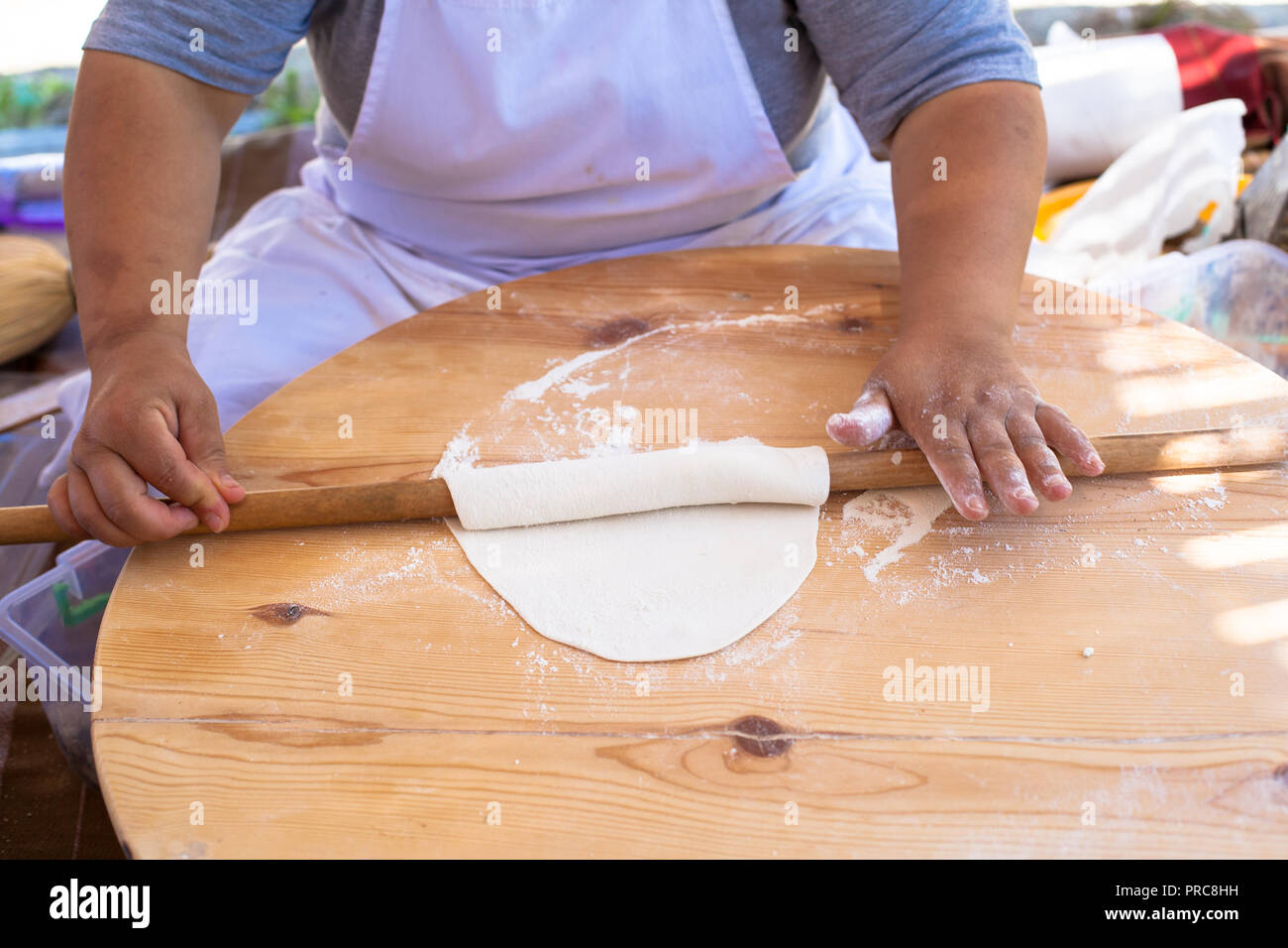 Pita bread with cottage cheese and greens. Preparing traditional bread on the street market. Stock Photo