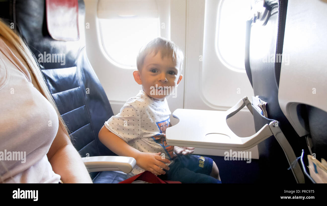 Happy smiling toddler boy sitting in airplane seat Stock Photo Alamy