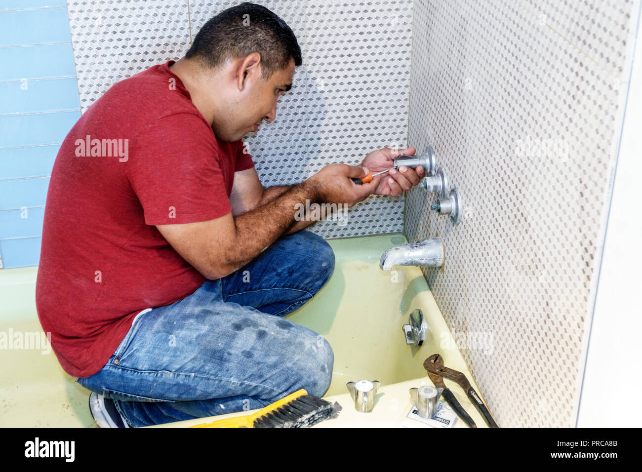 Miami Beach Florida,contractor,Hispanic man men male,bathroom plumbing shower installation installing,working,FL180630092 Stock Photo