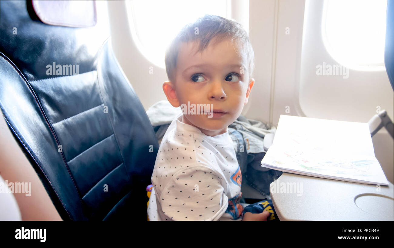 Portrait Of 2 Years Old Toddler Boy Flying In Airplane Stock