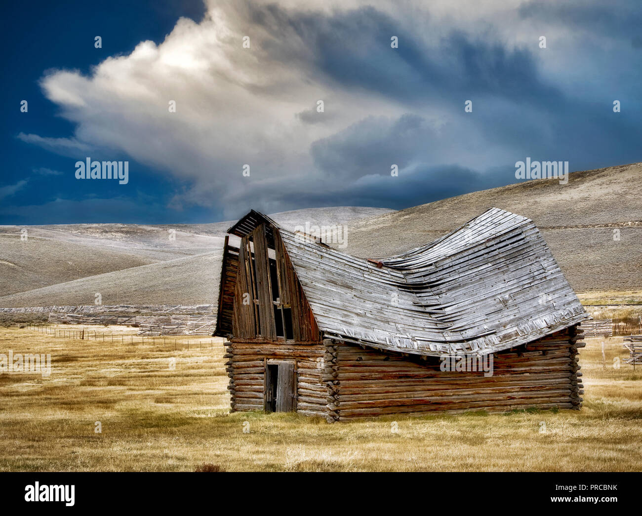 Fallen down barn with Thunderclouds. Montana. Stock Photo