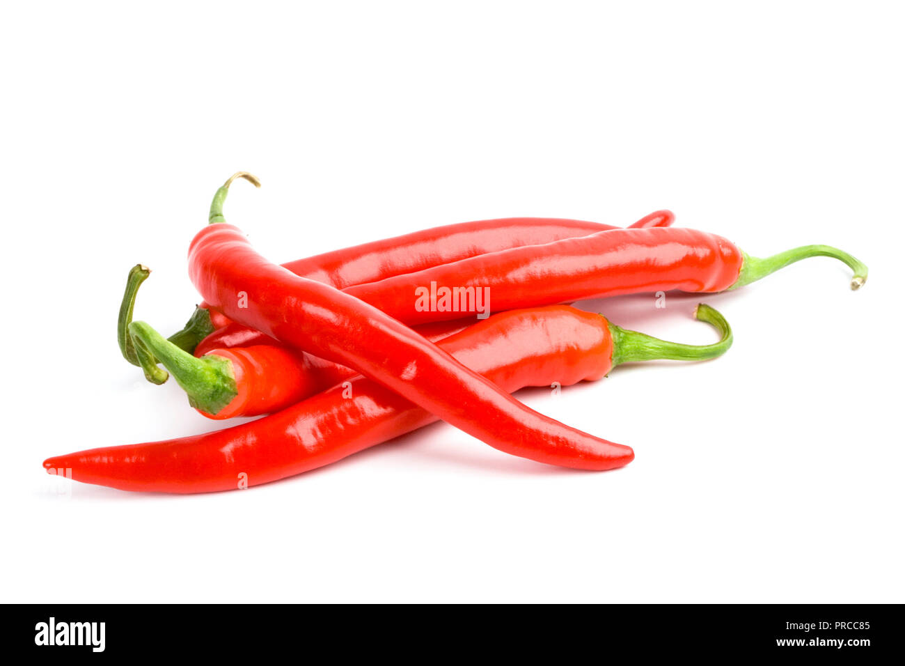 four red chili peppers isolated on white background Stock Photo - Alamy