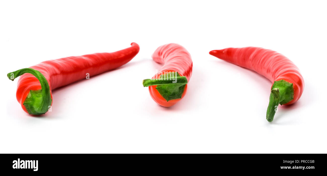 three red chili peppers on white background Stock Photo - Alamy