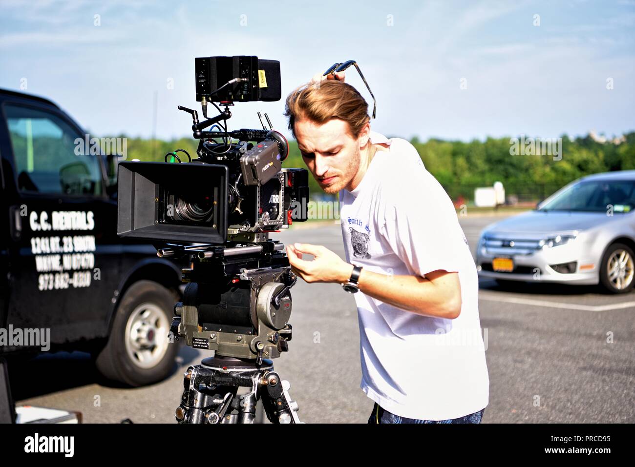New York, NY; Aug 2018: A cinematographer peers through his view finder to set up his shot Stock Photo