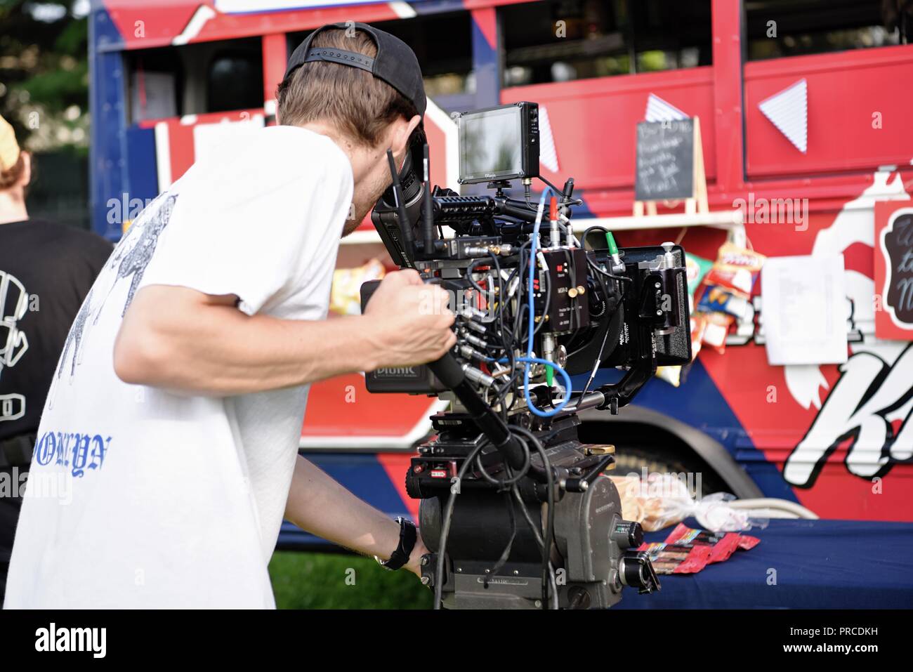 New York, NY; Aug 2018: A cinematographer peers through his view finder to set up his shot Stock Photo