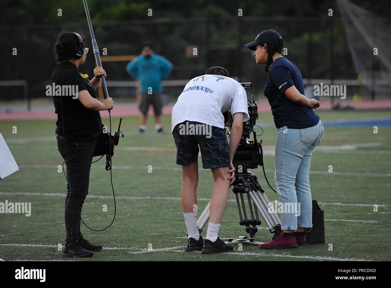 New York, NY; Aug 2018: A film crew shoots a scene on a football field Stock Photo