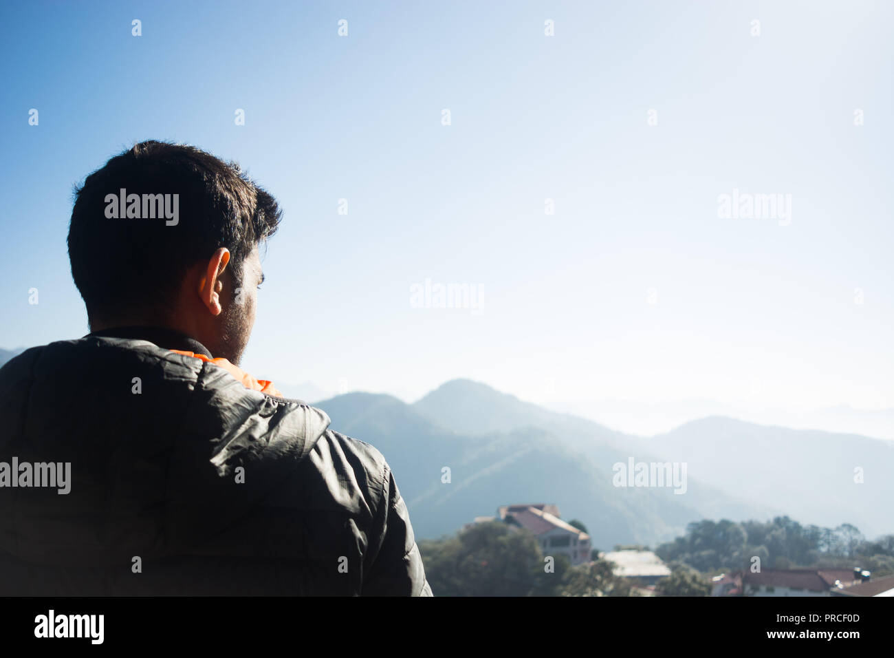 A boy overlooking the Mussoorie hills in the morning Stock Photo