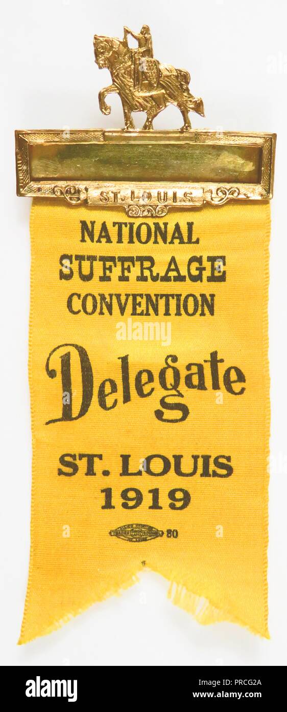 Yellow suffrage ribbon or badge, issued to delegates attending the National American Woman Suffrage Association convention in St Louis, topped with a gold-colored, bar pin in the shape of a woman on horseback (likely depicting suffragist Inez Milholland Boissevain) manufactured for the American market, 1919. Photography by Emilia van Beugen. () Stock Photo