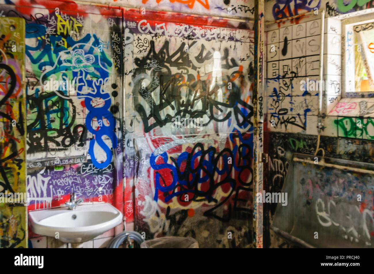 Graffiti on the walls of a public toilet in Freetown Christiania, Copenhagen, Denmark. Stock Photo