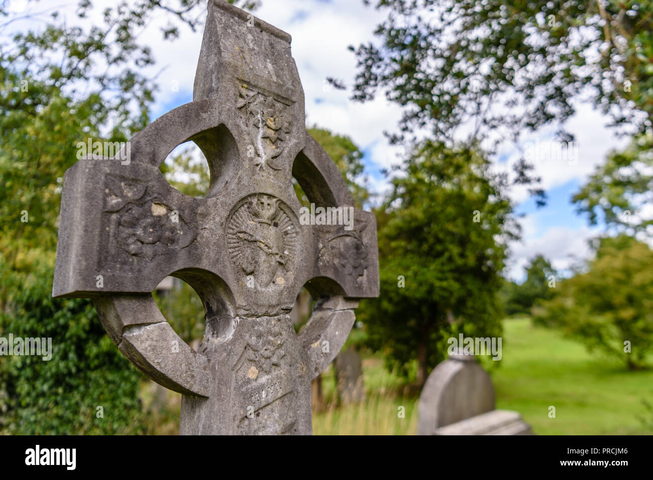 Celtic Cross with a sacred heart in an Irish graveyard. Stock Photo