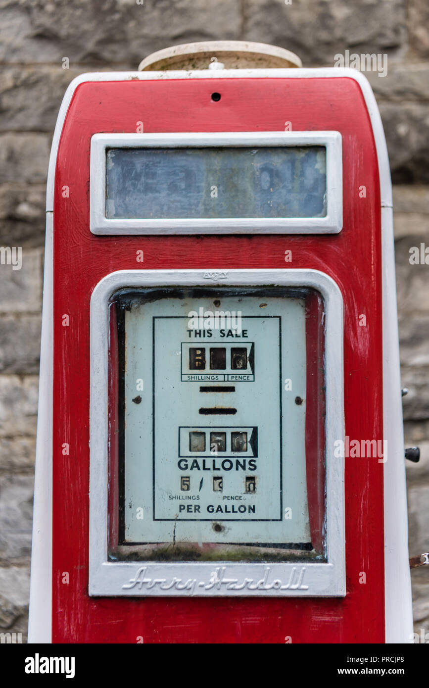 Old fashioned red petrol pump on the street in an Irish village. Stock Photo