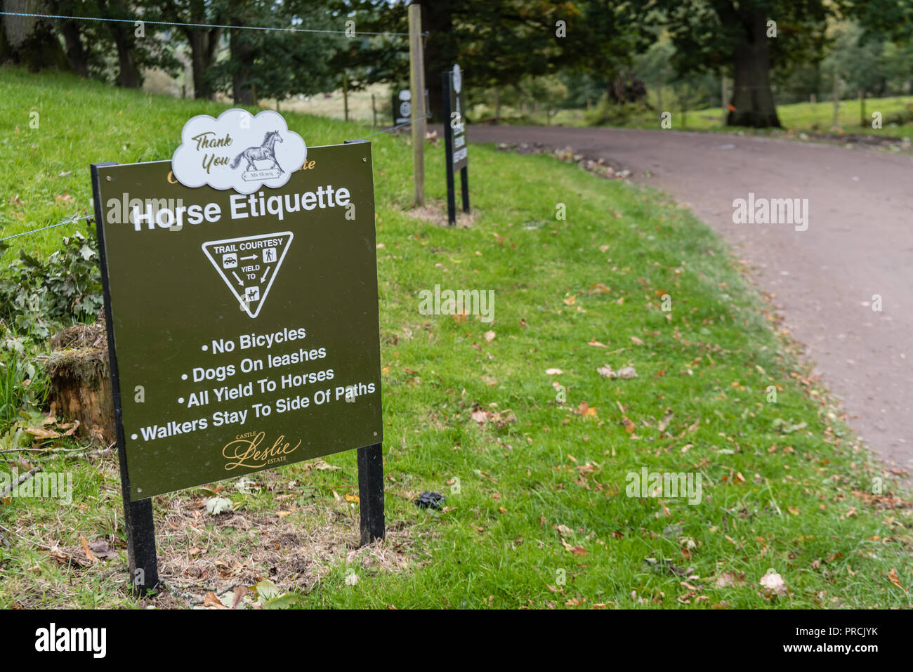 Sign warning visitors about horse etiquette: horses have priority over pedestrians and vehicles at a county lane. Stock Photo