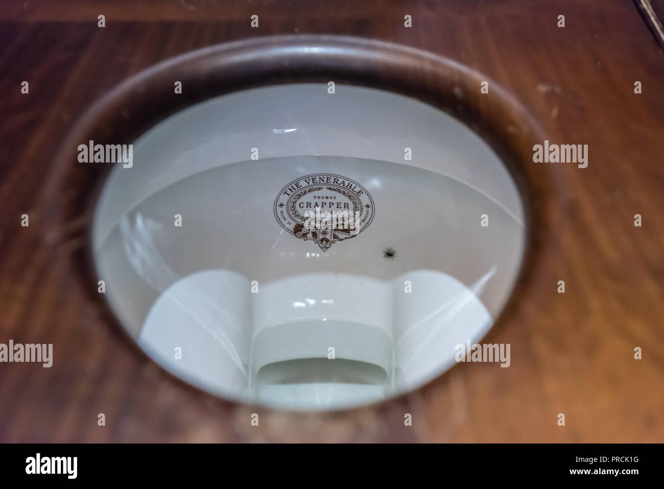 Logo on an old fashioned bathroom sink and taps made by Thomas Crapper and Company Stock Photo