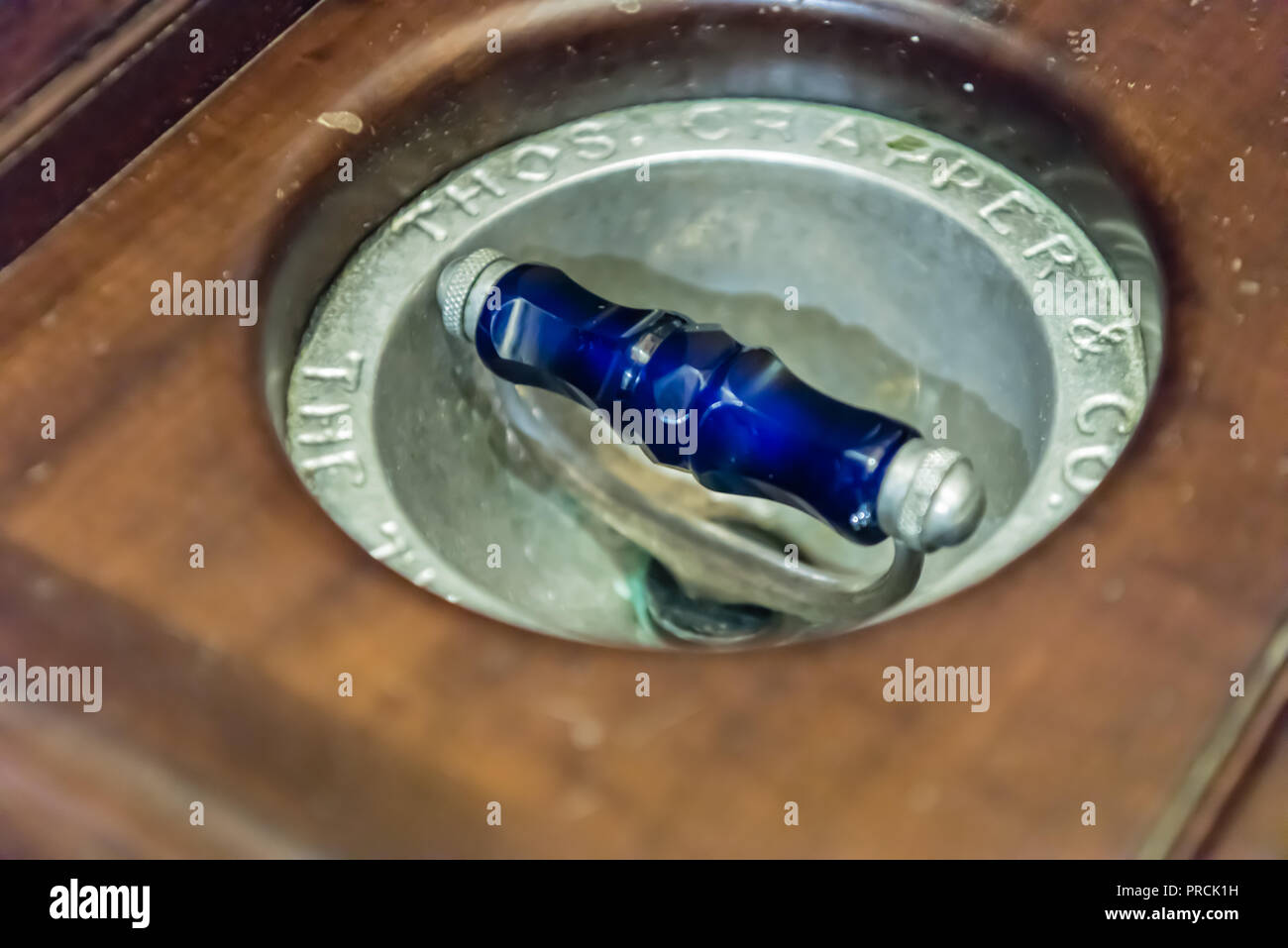 Flush handle of an old fashioned toilet made by Thomas Crapper and Company Stock Photo