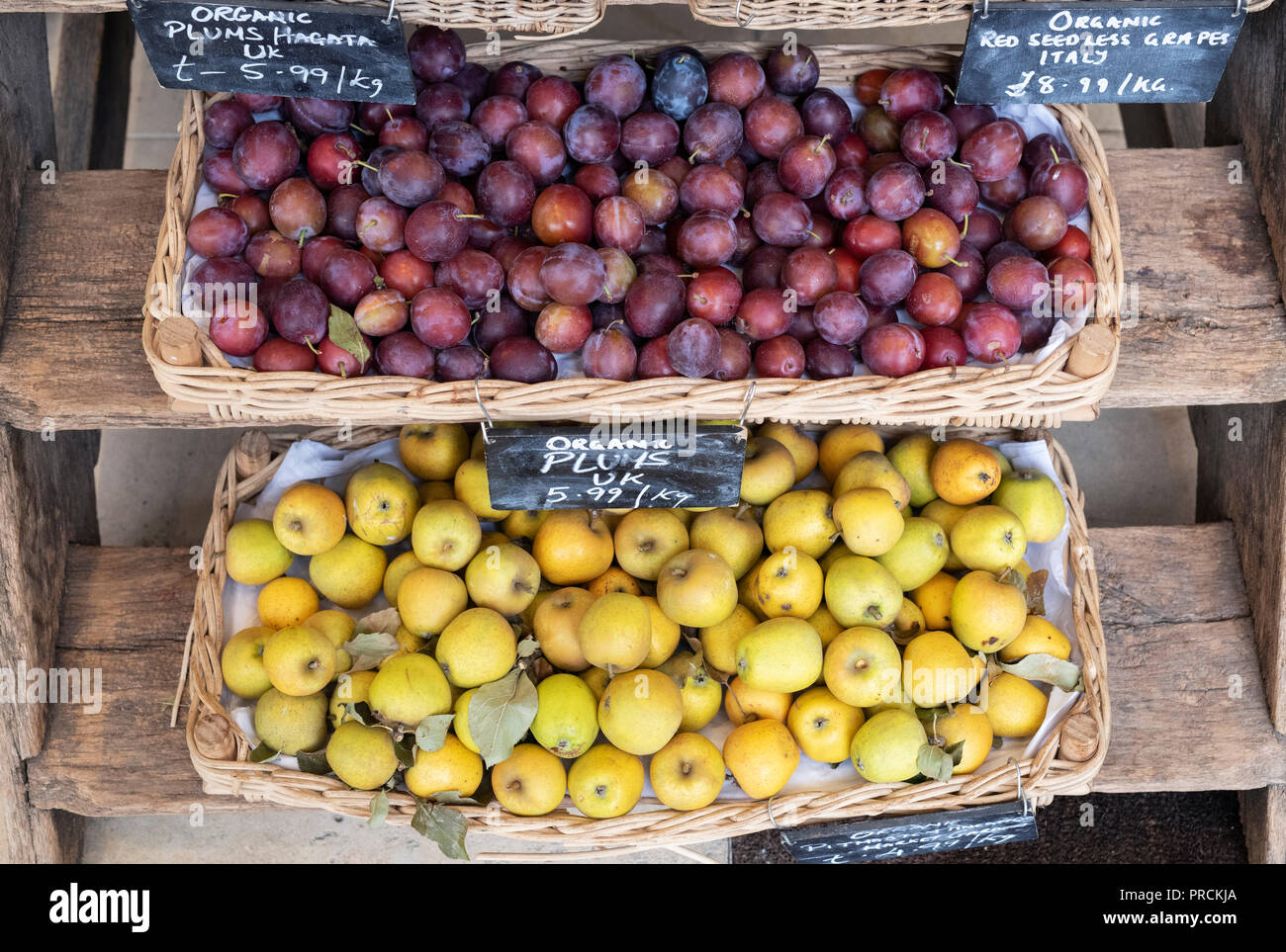 Organic plums and pitmaston pineapple apples for sale at Daylesford Organic farm shop autumn festival. Daylesford, Cotswolds, Gloucestershire, England Stock Photo