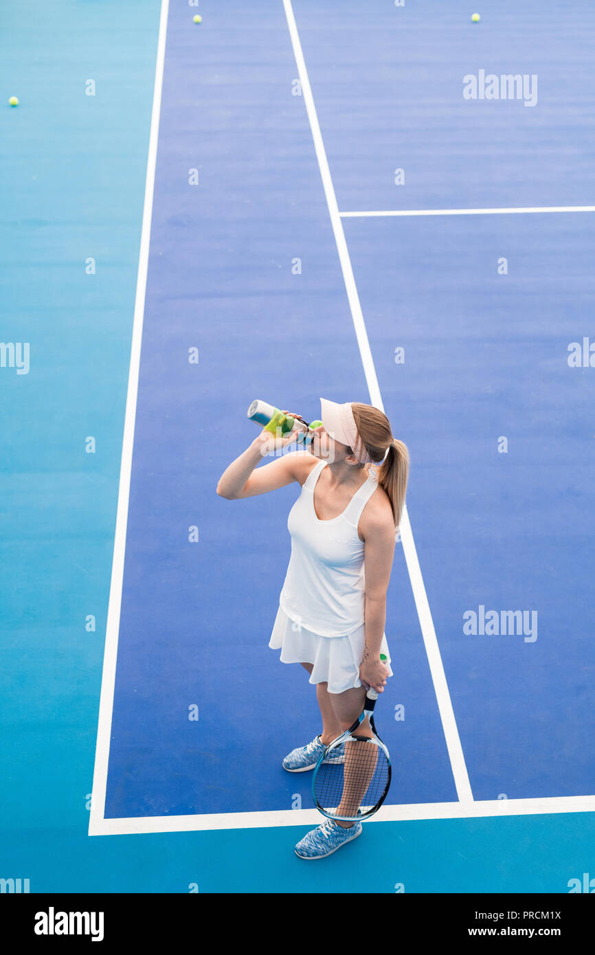 Woman Drinking Water in Tennis Court Stock Photo Alamy