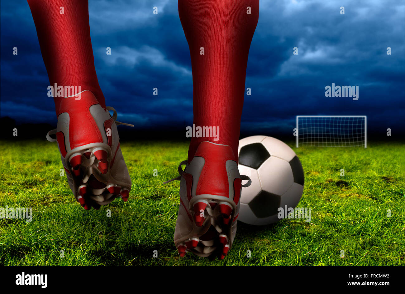 soccer player legs and feet ready to hit a ball toward the goal Stock