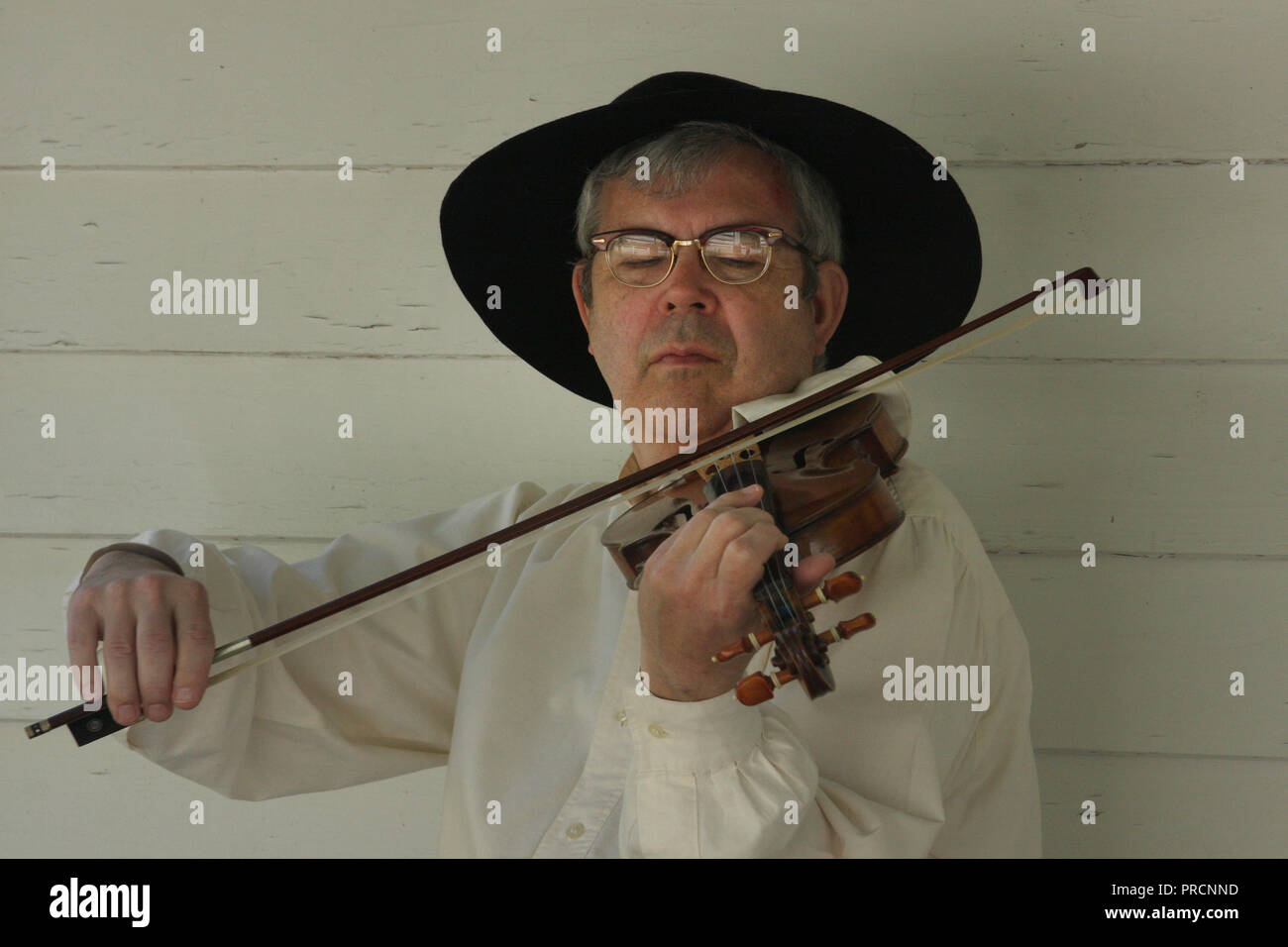 Man playing violin dressed in old traditional American (colonial) clothing Stock Photo