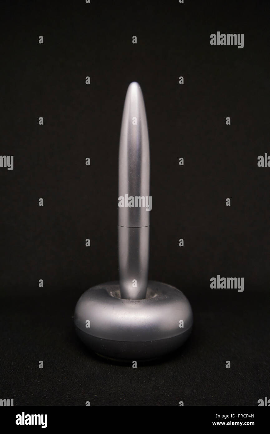 Silver pen on a black background. Stock Photo