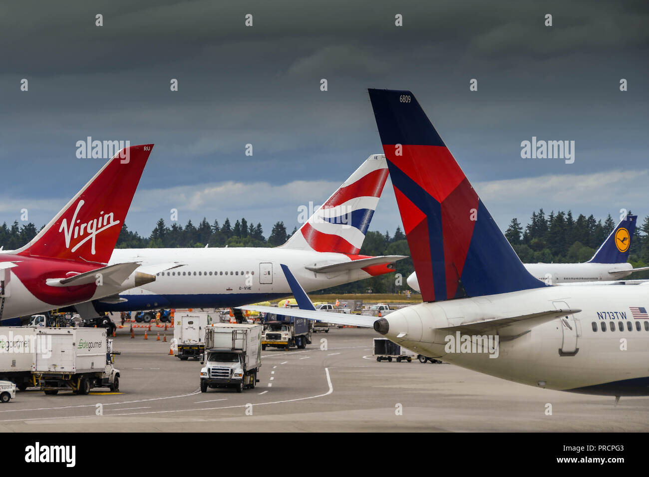 SEATTLE TACOMA AIRPORT, WA, USA - JUNE 2018: Tail fins of aircraft operated by British Airways, Virgin Atlantic and Delta Airlines at Seattle Tacoma a Stock Photo