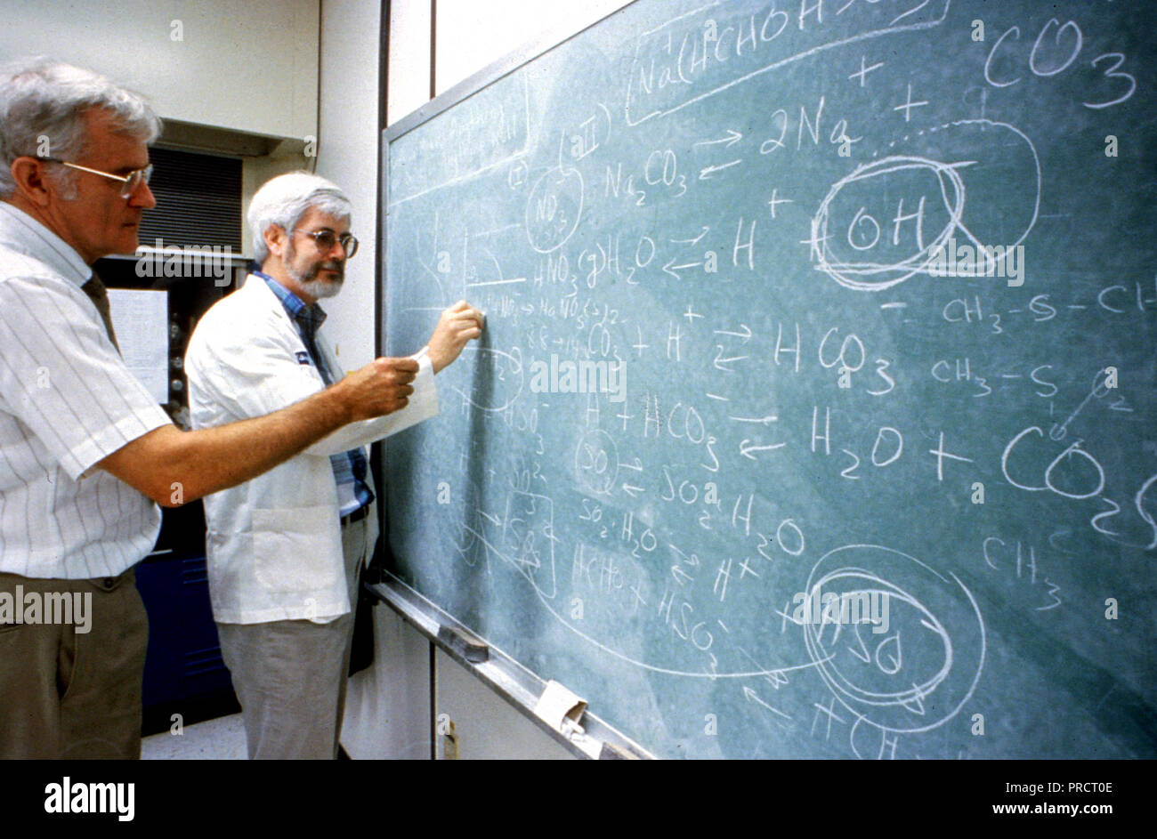 EPA scientists analyzing formulas on chalkboard ca. 1996 Stock Photo ...