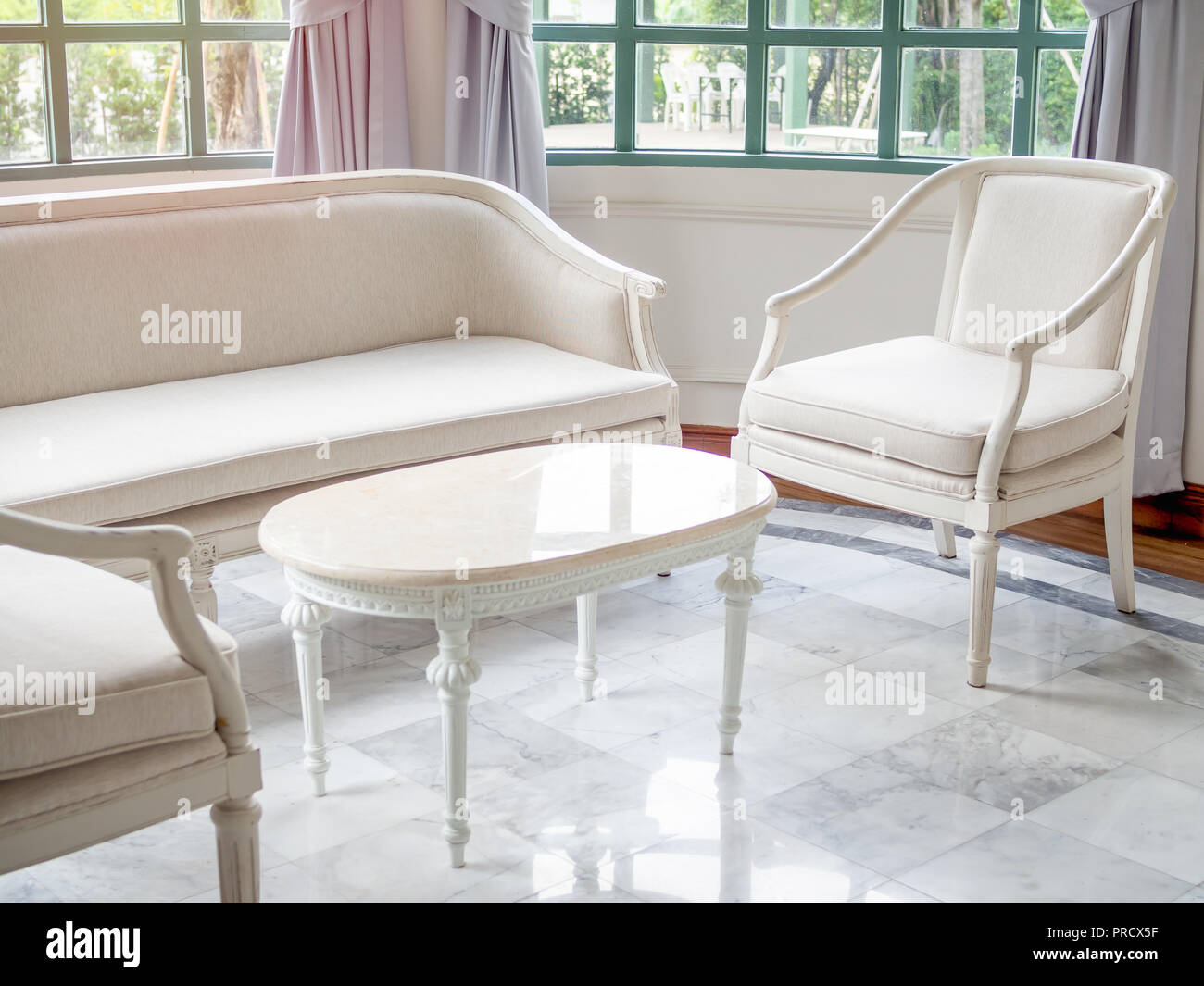 Vintage Luxury White Sofa Chair And Table Near The Window Glass