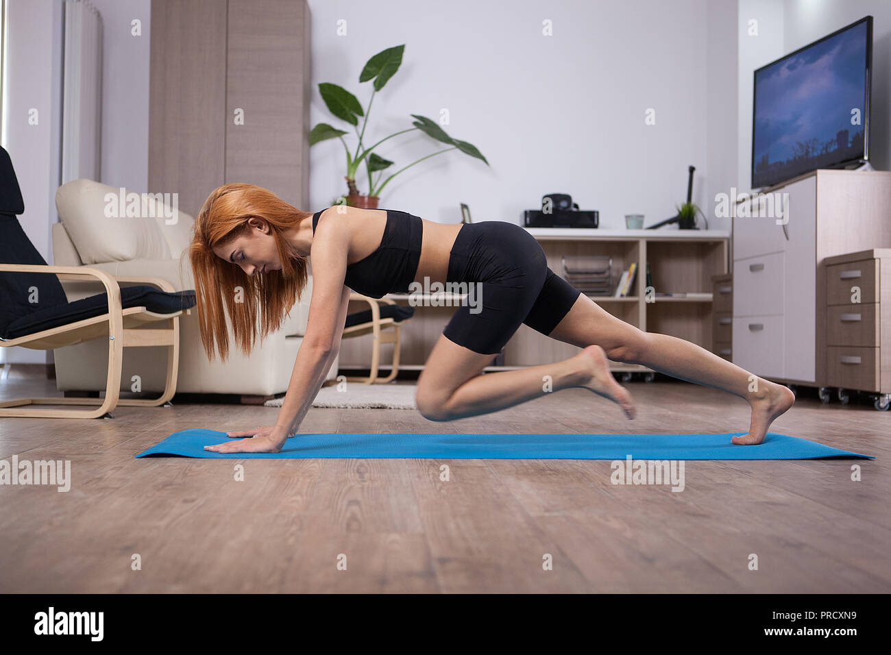 Young beautiful woman doing abs during her abs program. Professional training. Stock Photo