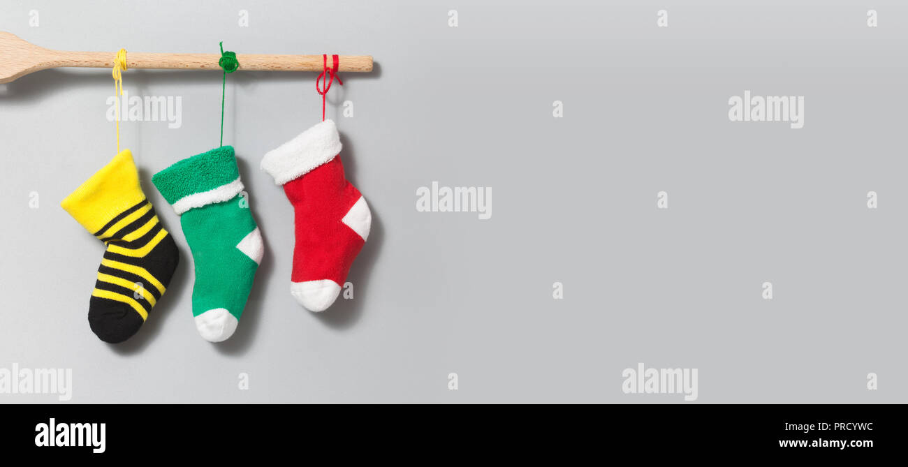 Christmas Santa socks on gray background Colorful christmas stockings decoration element yellow green red