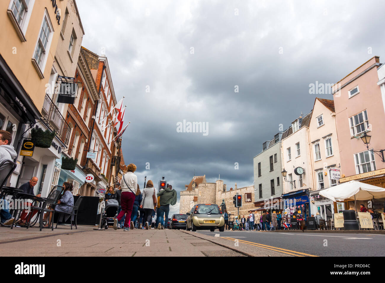 A low angle view of The High Street in Windsor looking towards Windsor Castle on a cloudy autumn day, Stock Photo