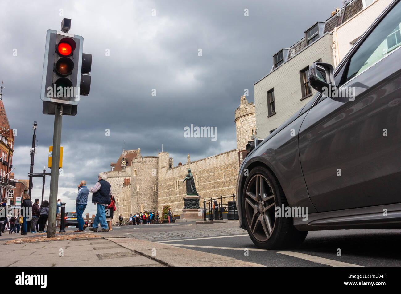 A car waits at a red traffic light at a pedestrian crossing on High Street, Windsor near Windsor Castle. Stock Photo
