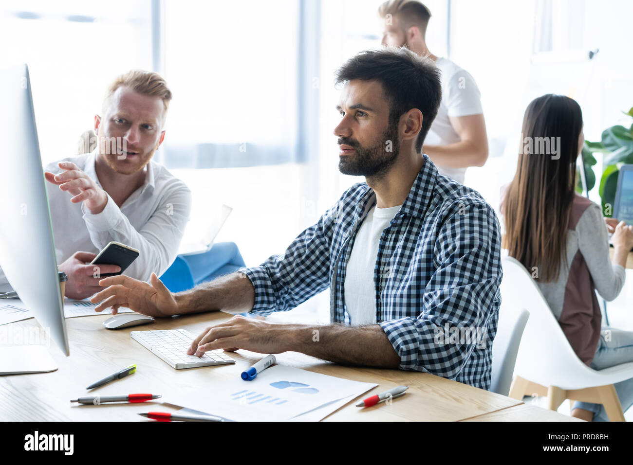 Coworking process, designers team working modern office Stock Photo