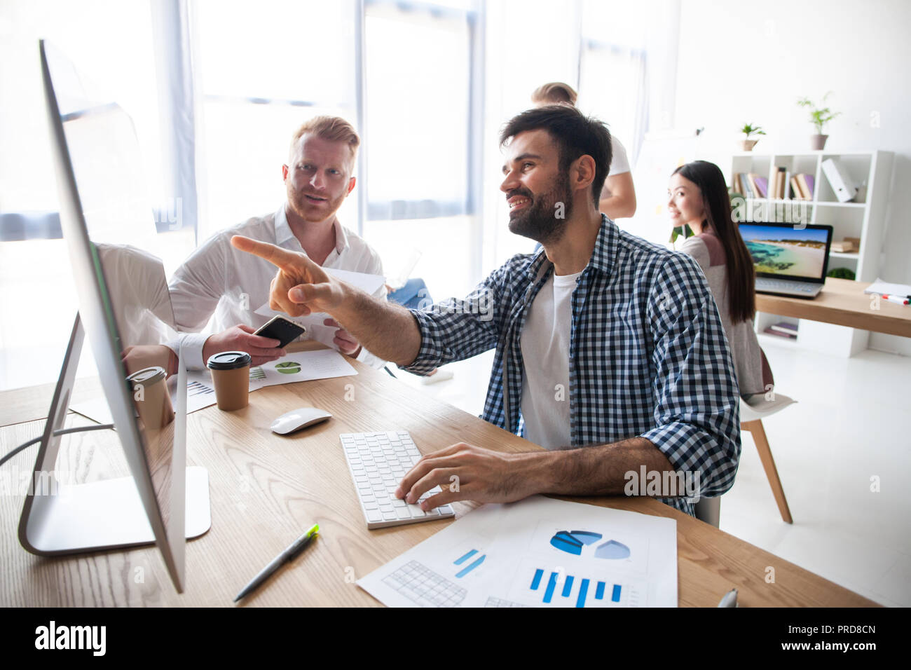 Coworking process, designers team working modern office Stock Photo