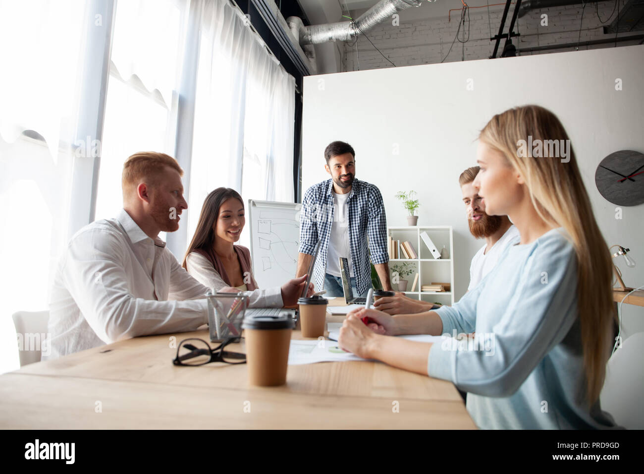 Young team of coworkers making great business discussion in modern coworking office.Teamwork people concept Stock Photo