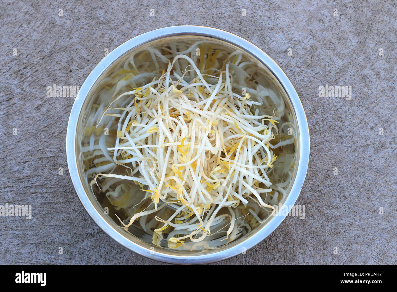 Close up of fresh mung bean sprouts in stainless steel bowl isolated Stock Photo
