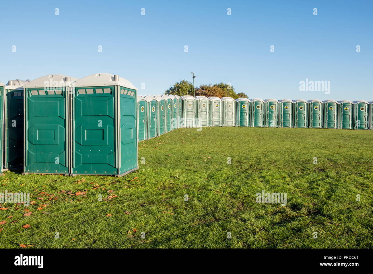 A line of temporary toilet cubicles. Lots of portable toilets in a field, Nottingham, England, UK Stock Photo