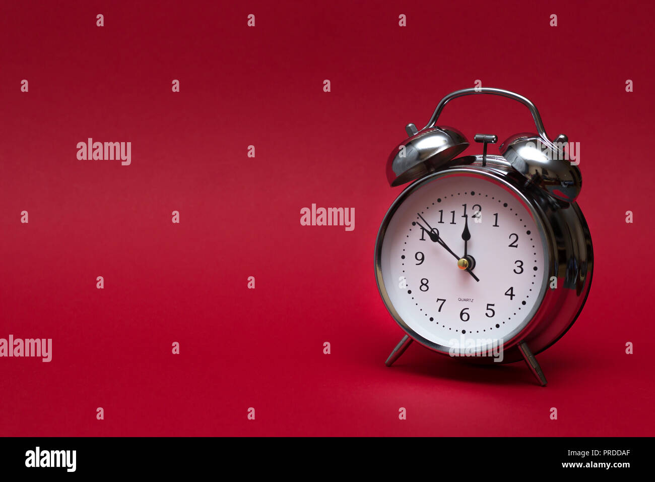 red alarm clock on red background. close up shot. top view. For time concept. Stock Photo