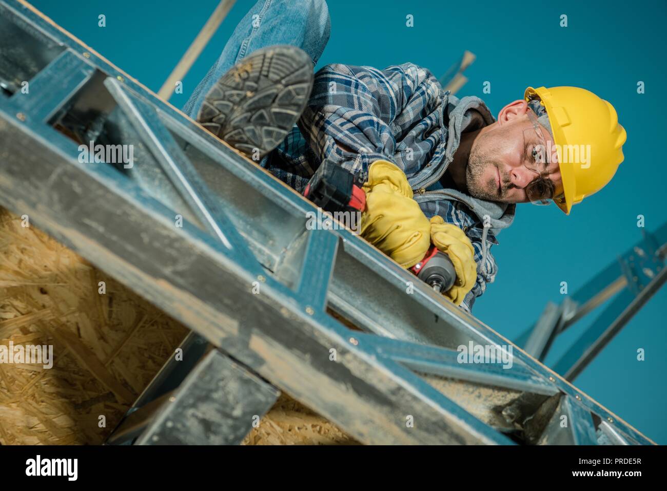 Caucasian Building Worker in His 30s. Construction Site Closeup. Steel Frame Elements. Stock Photo