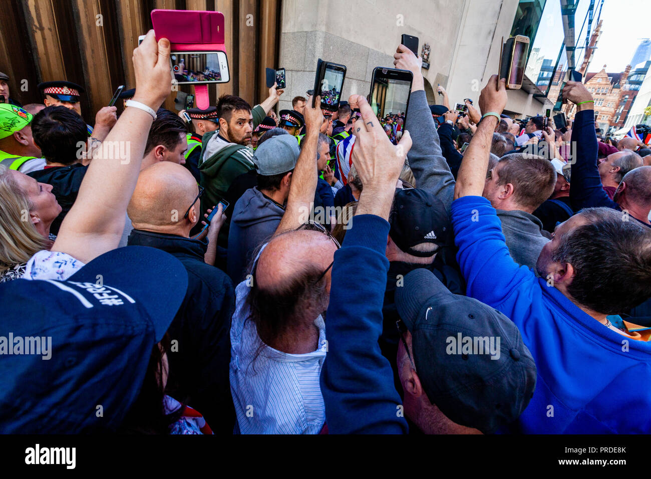 Supporters Of The Right Wing Activist Tommy Robinson Film Him With Their Mobile Phones Leaving 'The Old Bailey' Court, London, UK Stock Photo