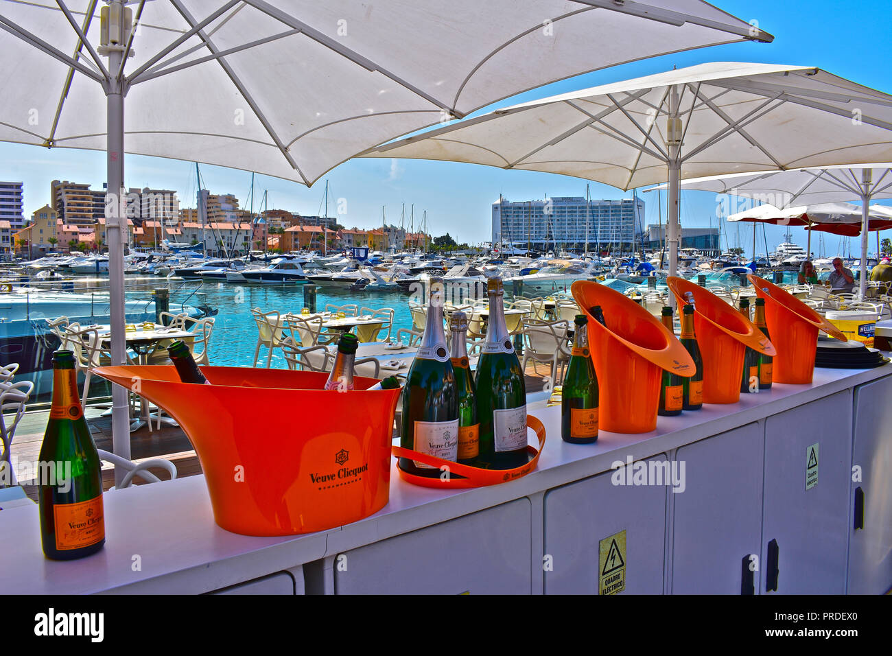 Verve Clicquot champagne bottles lined up along the entrance to an up-market waterside restaurant at Vilamoura Marina Algarve, Portugal Stock Photo