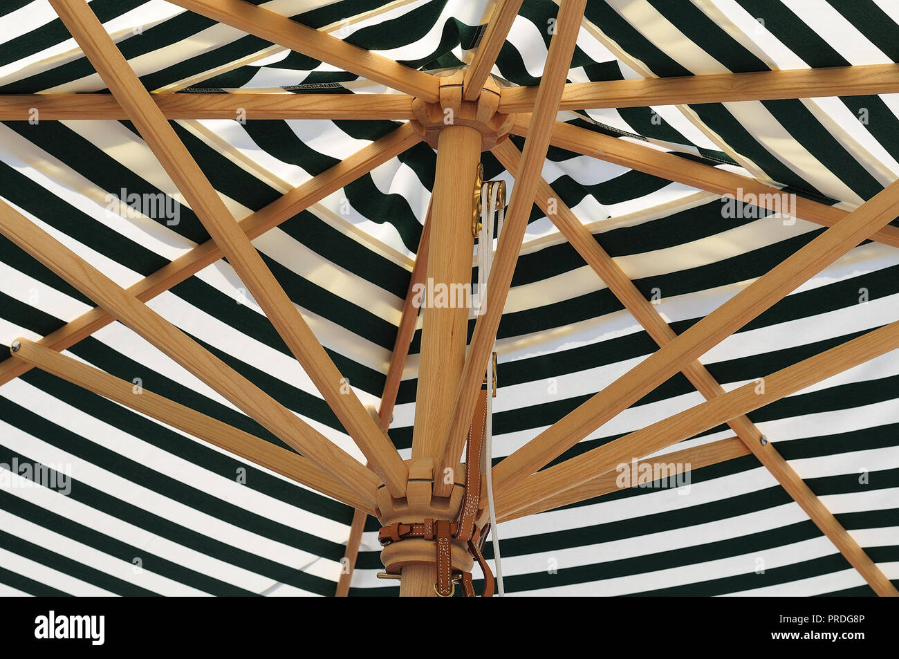 large parasol with green white striped canvas roof and wooden linkage Stock  Photo - Alamy