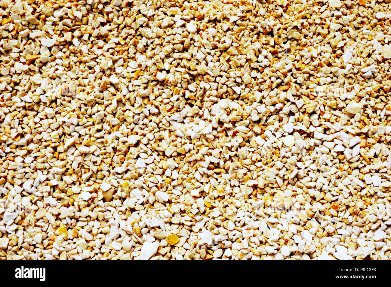 Pebble background. Small fine gravel in warm earth tone color. Big dimension background Stock Photo
