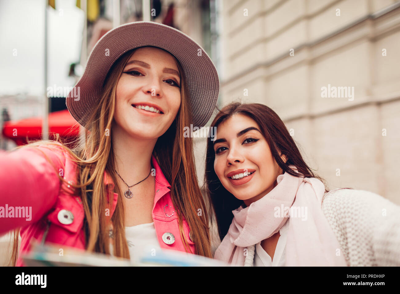 Women tourists taking selfie going sightseeing in Odessa. Happy friends travelers having fun during vacation Stock Photo