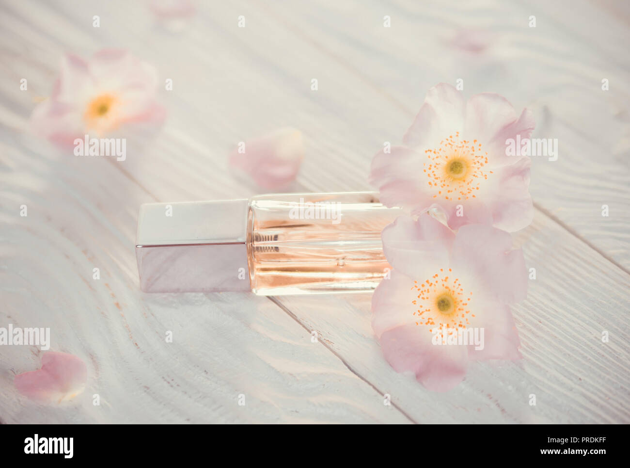 Bottle of perfume with flowers on white background Stock Photo Alamy