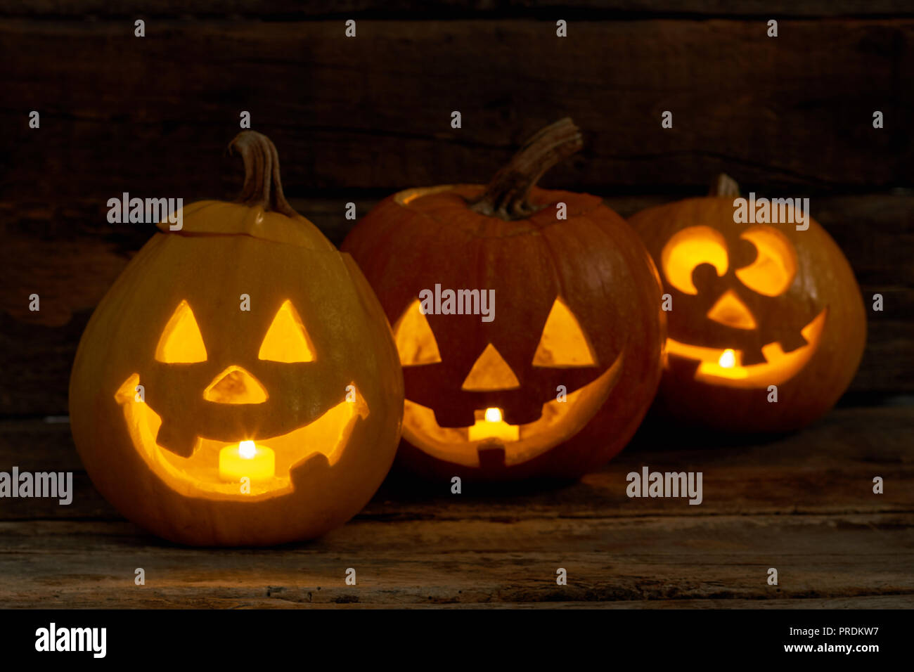 Funny Halloween pumpkins with burning candles. Stock Photo