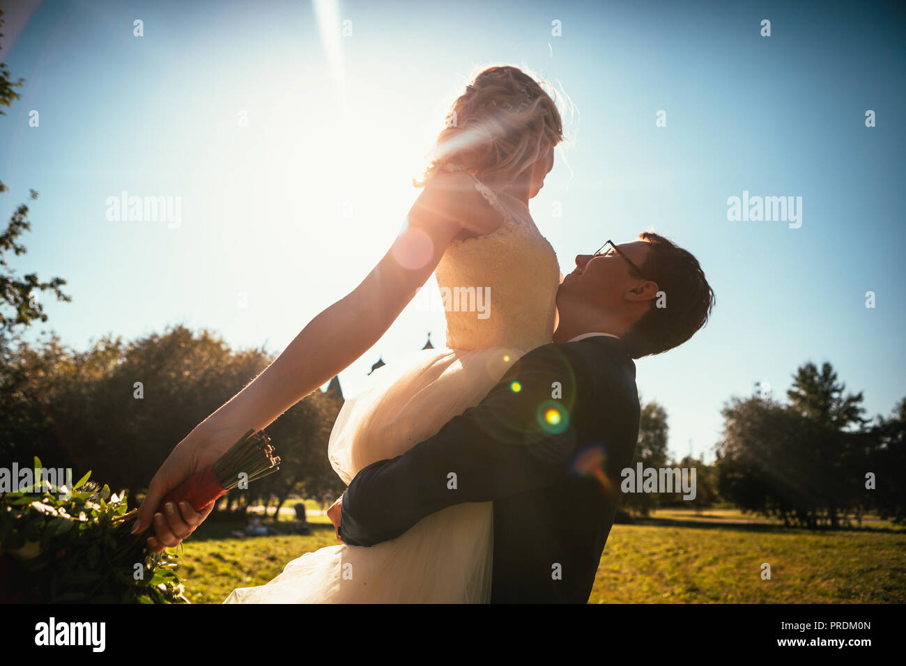 Dancing young bride and groom sunlight background Stock Photo - Alamy