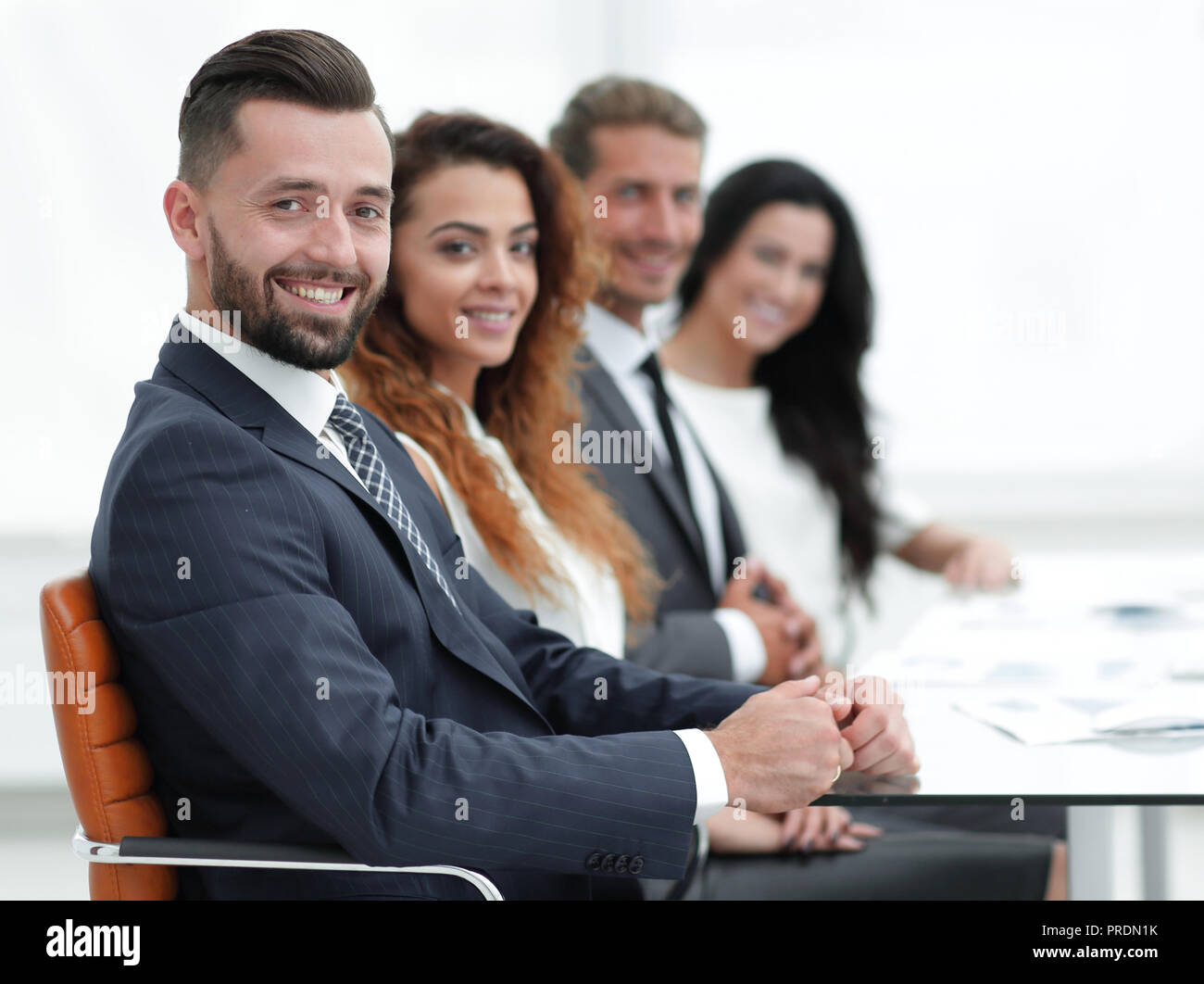 group of business people sitting at the desktop Stock Photo - Alamy
