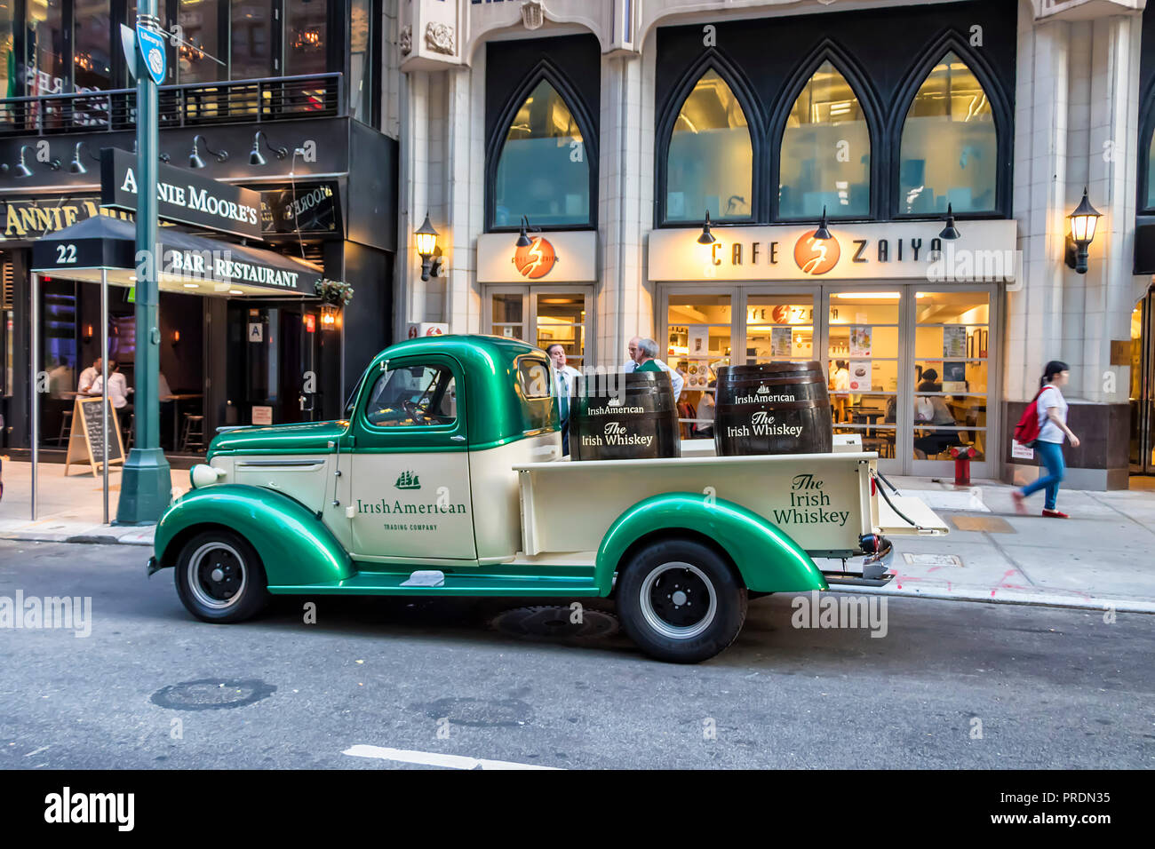 New York City, USA - June 12, 2017:  Classic Green and White Chevrolet 3100 pickup truck of 'IrishAmerican' company, parked in library way, New York C Stock Photo